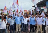 Caption. Ketua DPC Partai Gerindra, Chusni Mubarok dan tokoh masyarakat Malang selatan Abah Ropi'i bersama Gubuk Relawan Malsel pawai dalam rangka memenangkan Prabowo - Gibran