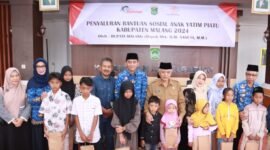 Caption. Bupati Malang didampingi Pj Sekretaris Daerah, Ketua Tim Penggerak PKK dan Camat Ampelgading saat menyerahkan bantuan sosial untuk anak yatim piatu 