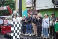 Ket foto. Wali Kota Batu Nurochman, mengibarkan bendera start tanda diberangkatkan 'Mlaku Bareng Sedoyo Sehat dan Bazar Sehat” di Alun-alun Kota Batu