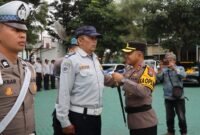 Ket foto. Kapolres Batu, AKBP Andi Yudha Pranata, saat menyematkan atribut tanda dimulainya Operasi Zebra 2025