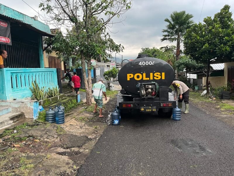 Ket foto. Petugas dari Polsek Lawang Polres Malang mendistribusikan air bersih pada warga masyarakat yang terdampak kekeringan