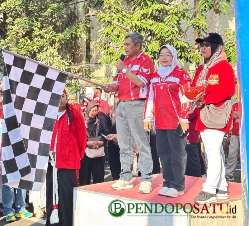 Kepala Bakorwil Malang, Asep Kusdinar mengibarkan bendera start dimulainya acara jalan sehat (Foto: bgs pendoposatu.id)